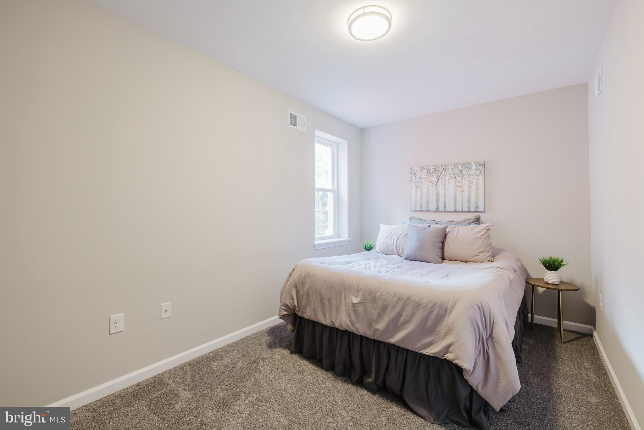 711 East Preston Street Baltimore, MD 21202 - Photo 15 of 27 a bedroom with a bed and window