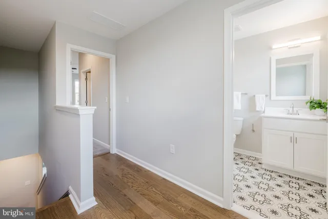 a bathroom with a sink a toilet a shower and a window