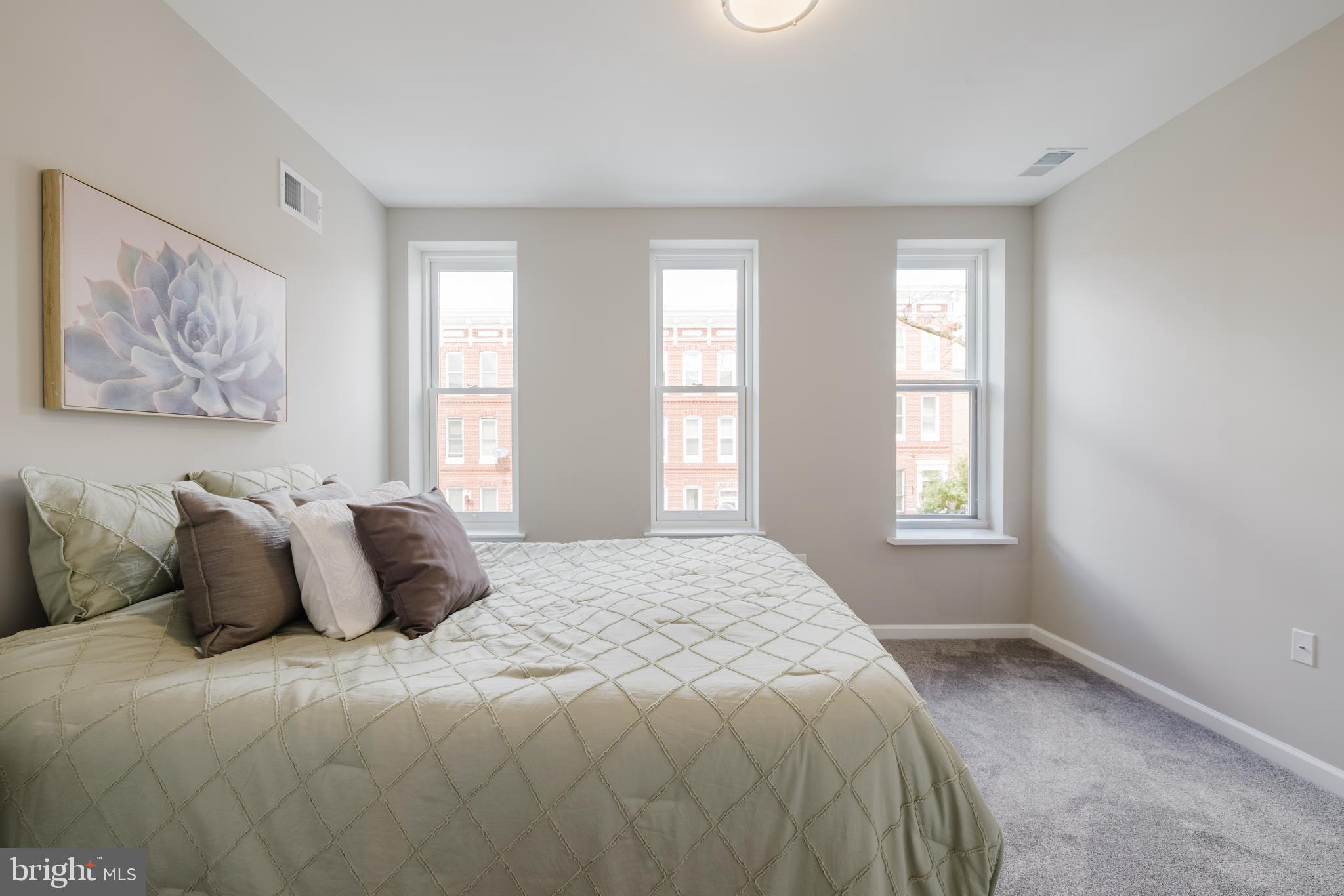 711 East Preston Street Baltimore, MD 21202 - Photo 18 of 27 a bedroom with a bed and a window