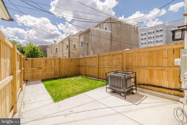 a view of a backyard with wooden fence