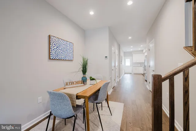 a view of a room with furniture and wooden floor