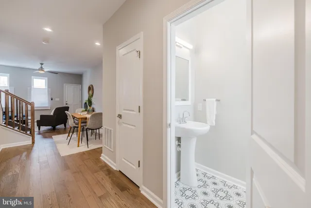a view of a hallway with furniture and wooden floor