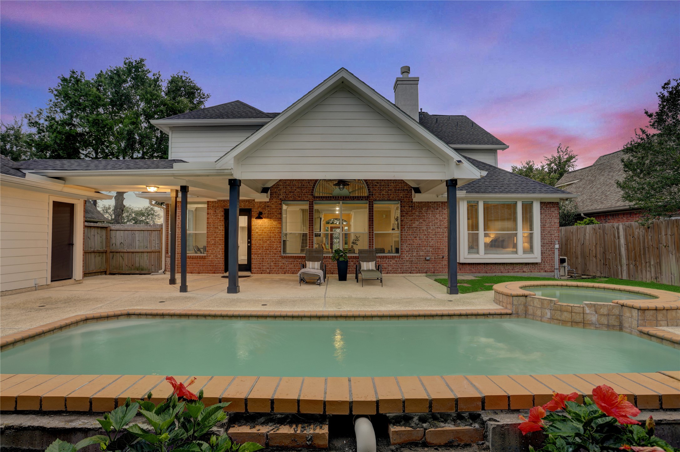 24418 Falcon Point Drive Katy, TX 77494 - Photo 33 of 40 Beautifully designed backyard with a spacious covered patio, pool, and spa, offering the perfect balance of shade and sun. The layout is ideal for entertaining, with plenty of room to relax and enjoy outdoor living.