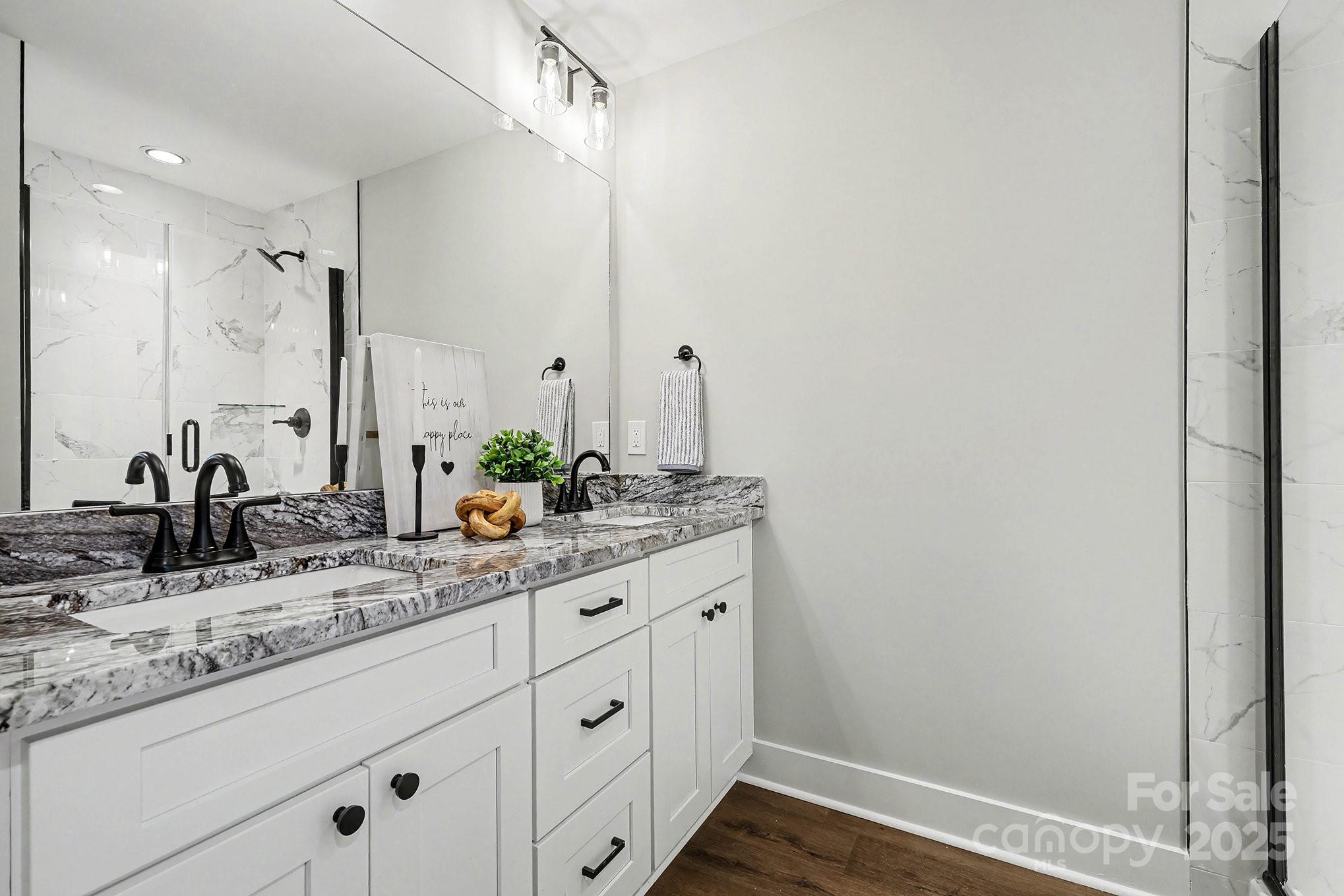 1230 Faith Road Salisbury, NC 28146 - Photo 15 of 26 a bathroom with a granite countertop sink and a mirror