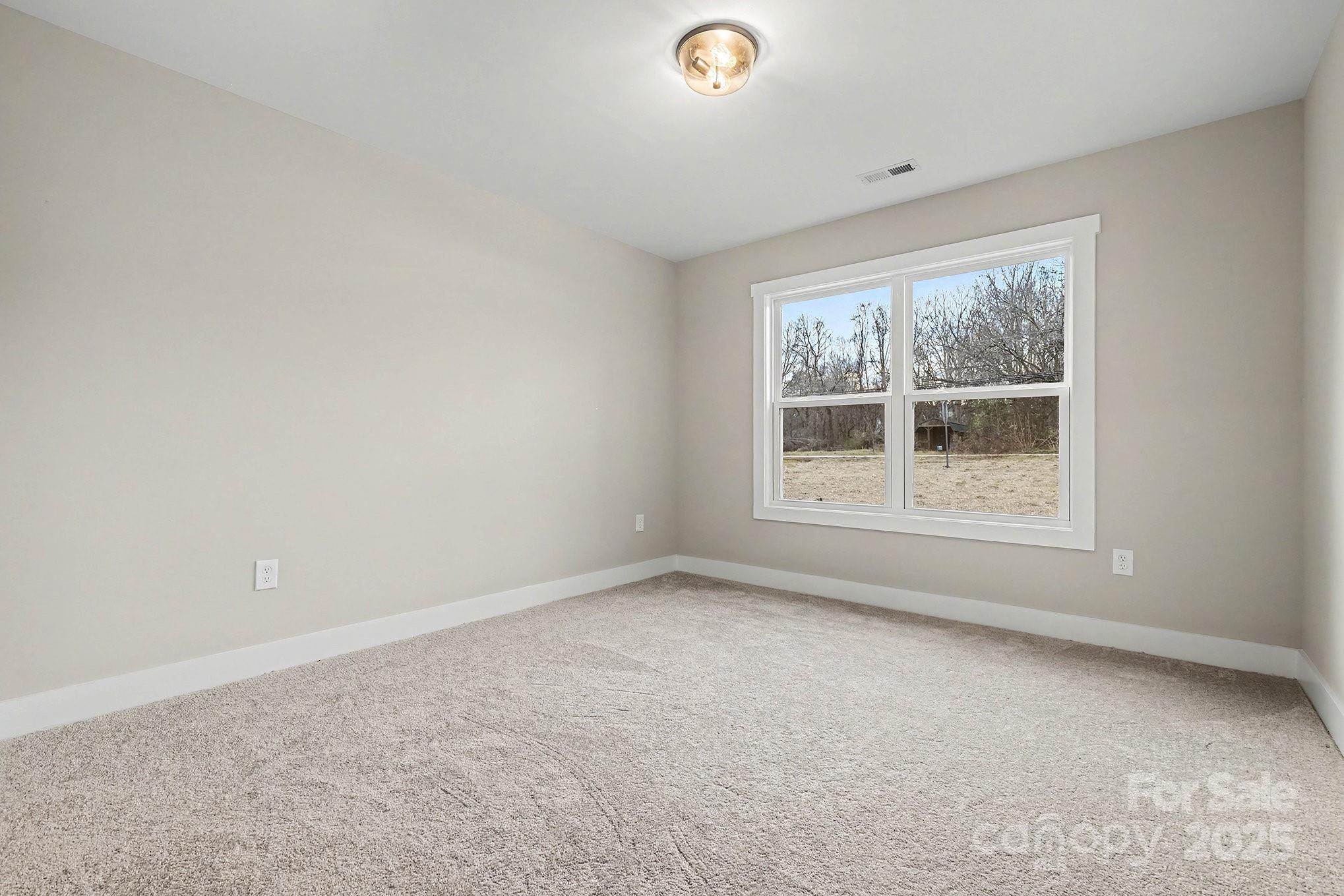 1230 Faith Road Salisbury, NC 28146 - Photo 18 of 26 an empty room with a window