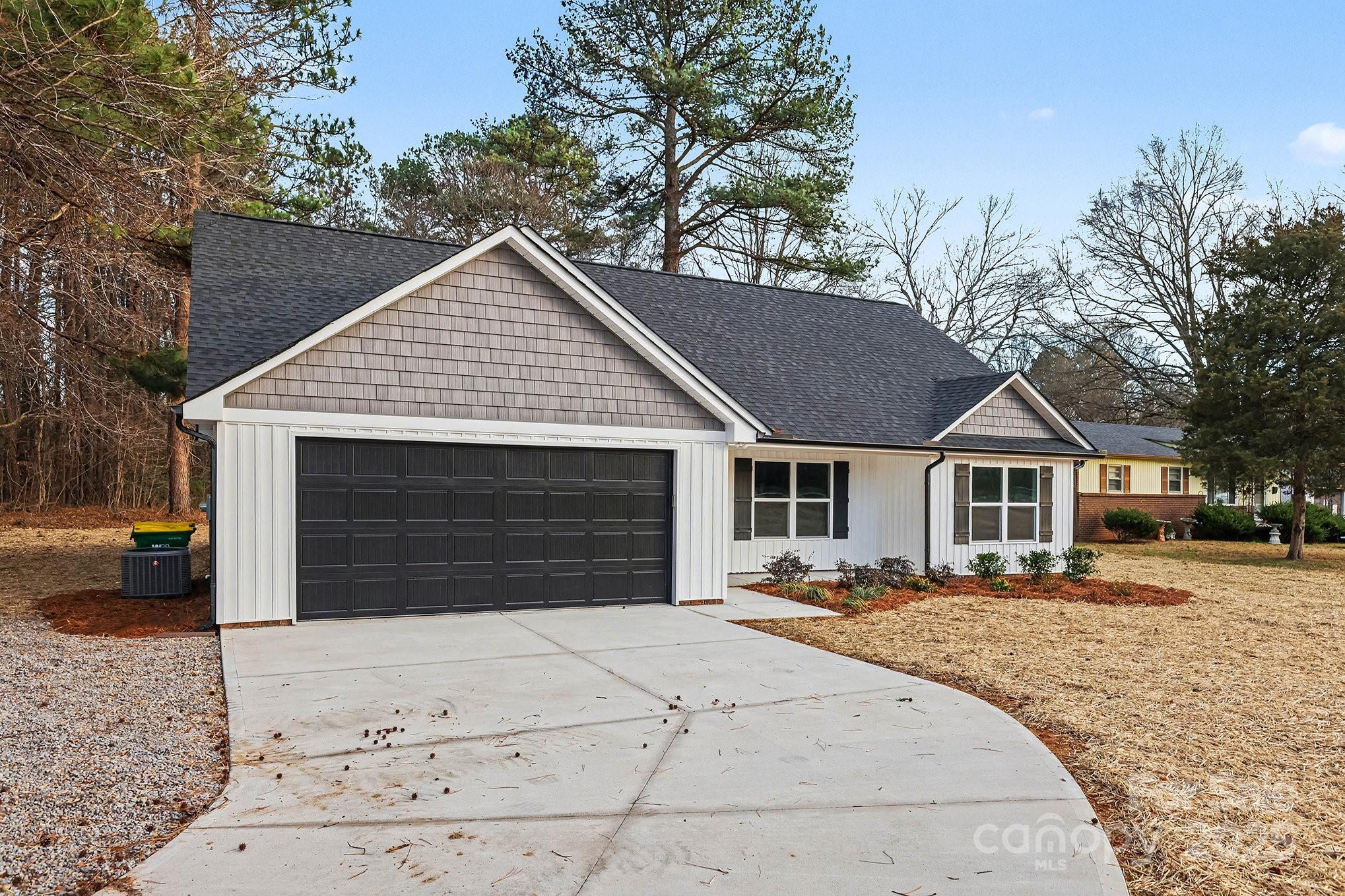 1230 Faith Road Salisbury, NC 28146 - Photo 2 of 26 a front view of a house with a yard and garage