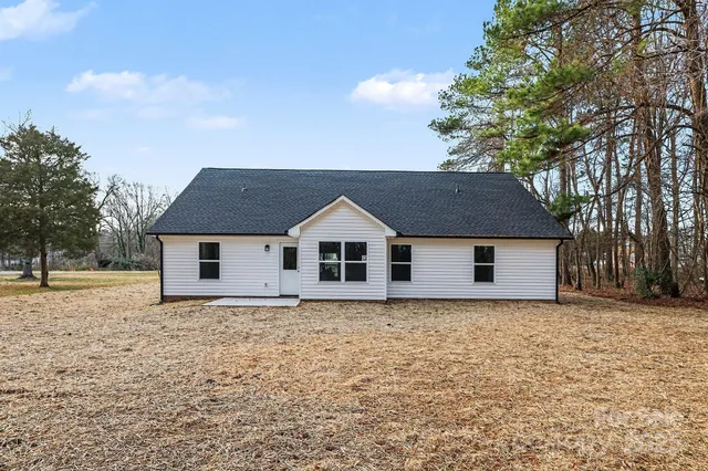 a house that has a tree in front of it