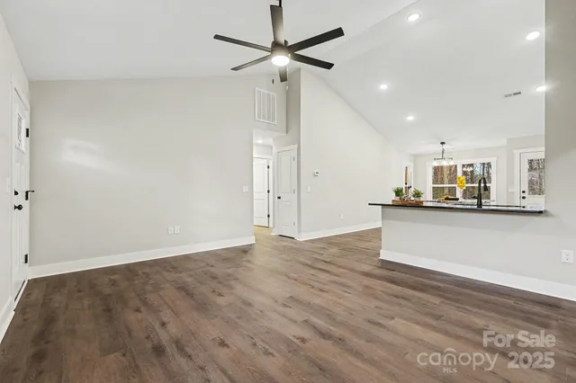 a view of kitchen with refrigerator and window