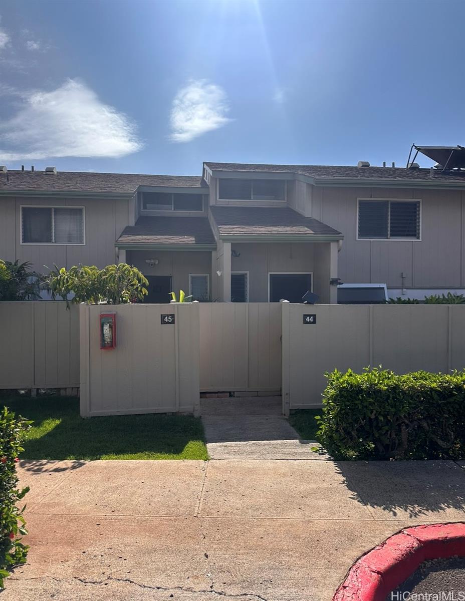 92-993 Makakilo Drive, Unit 45 Kapolei, HI 96707 - Photo 3 of 15 a front view of a house with a yard