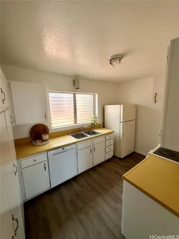 a kitchen with sink cabinets and wooden floor