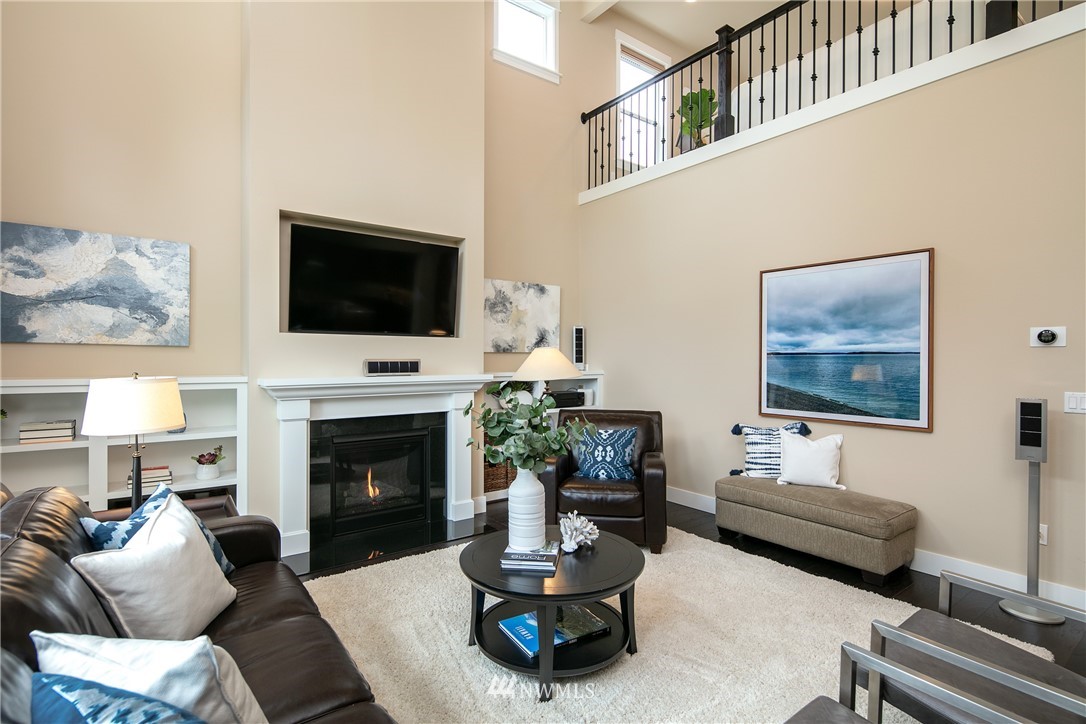 5206 Northeast 2nd Place Renton, WA 98059 - Photo 3 of 30 a living room with furniture a fireplace and a flat screen tv