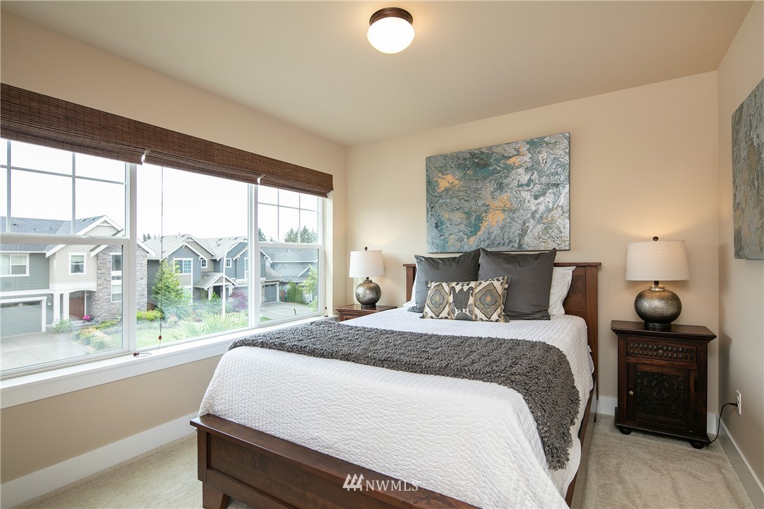 5206 Northeast 2nd Place Renton, WA 98059 - Photo 22 of 30 a bedroom with a large bed and a large window