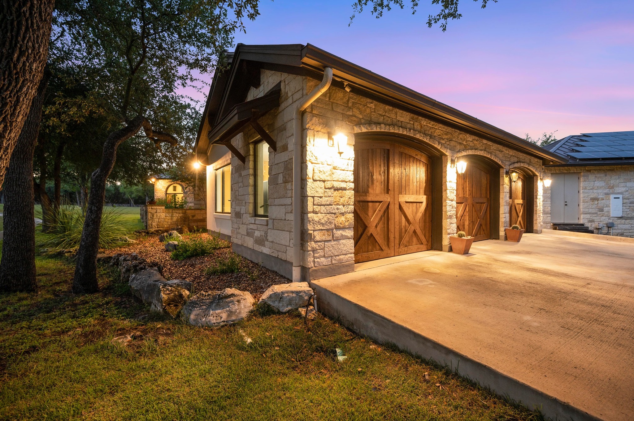 401 Trail Ridge Road Wimberley, TX 78676 - Photo 30 of 34 View of home's exterior featuring stone siding and driveway