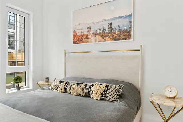 a bedroom with a bed and a window