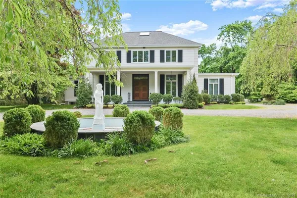 a front view of a house with garden