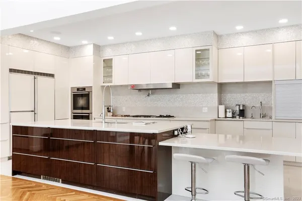 a kitchen with stainless steel appliances a sink stove and cabinets