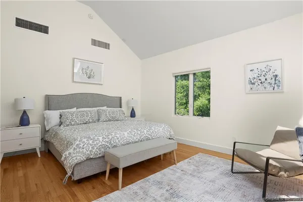 a bedroom with a bed and a couch