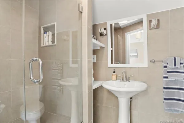 a bathroom with a sink toilet and shower