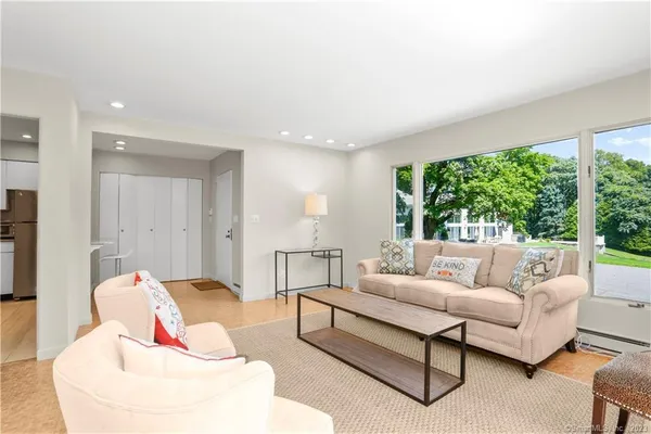 a living room with furniture and a large window