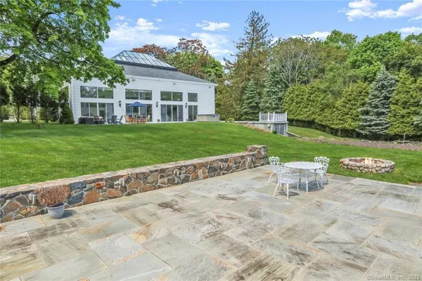 a view of a house with backyard and a sitting area