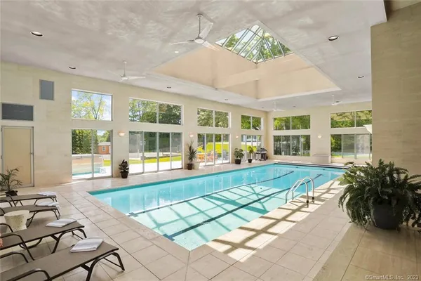 a swimming pool with outdoor seating and windows