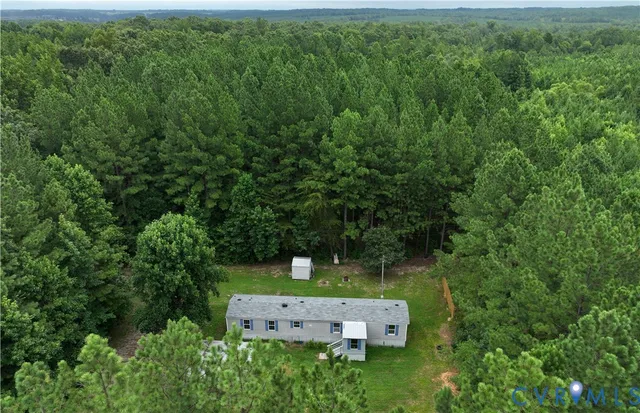 an aerial view of a house with a yard