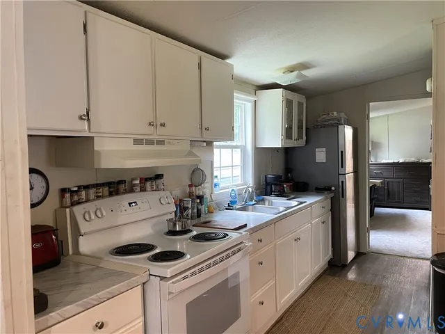 a kitchen with a stove a sink and a refrigerator