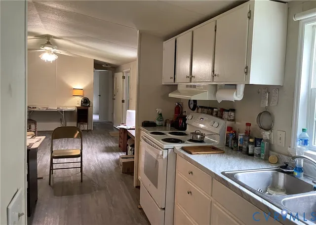a kitchen with stainless steel appliances a sink a stove and cabinets