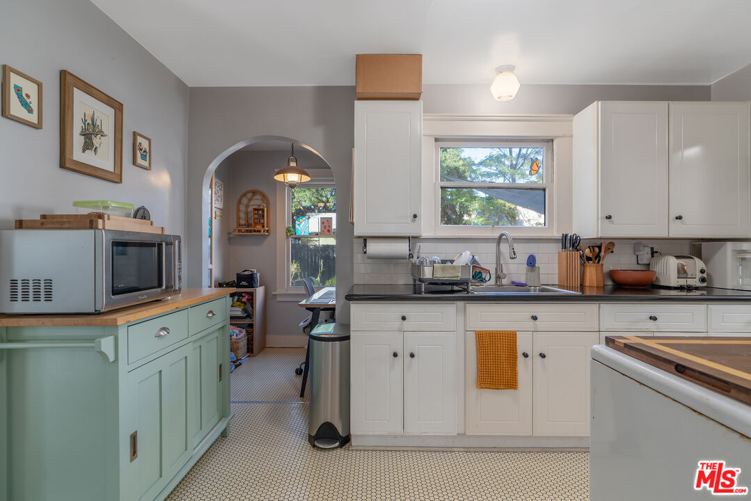 1767 Locust Street Pasadena, CA 91106 - Photo 9 of 28 a kitchen with a sink stove and cabinets