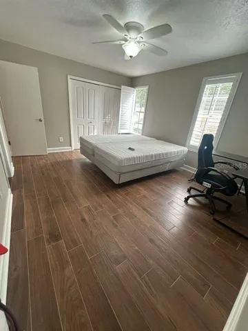 a bathroom with a granite countertop sink toilet a mirror and shower