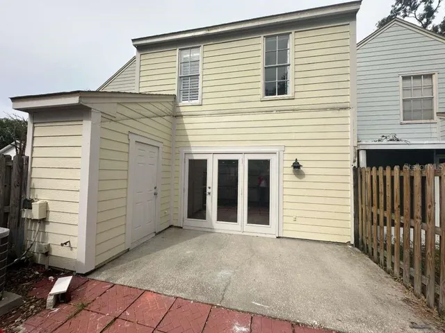 a view of a house with a yard garden and tree