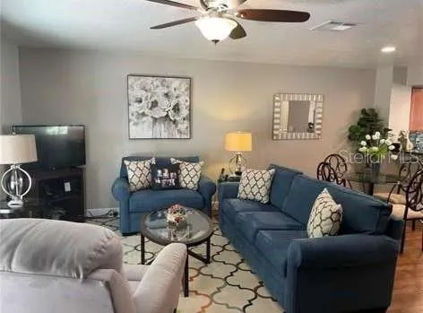 a living room with furniture and a flat screen tv