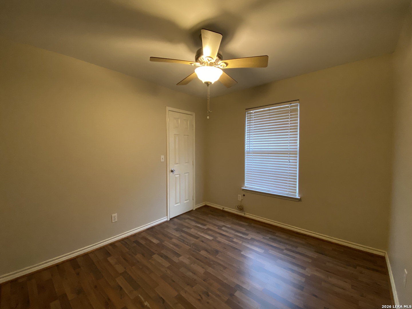 108 Ocotillo Jourdanton, TX 78026 - Photo 12 of 14 a view of an empty room with wooden floor and a window