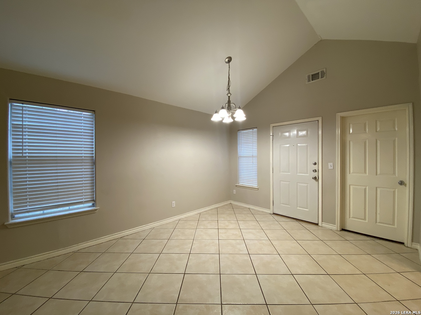 108 Ocotillo Jourdanton, TX 78026 - Photo 5 of 14 an empty room with chandelier fan and windows
