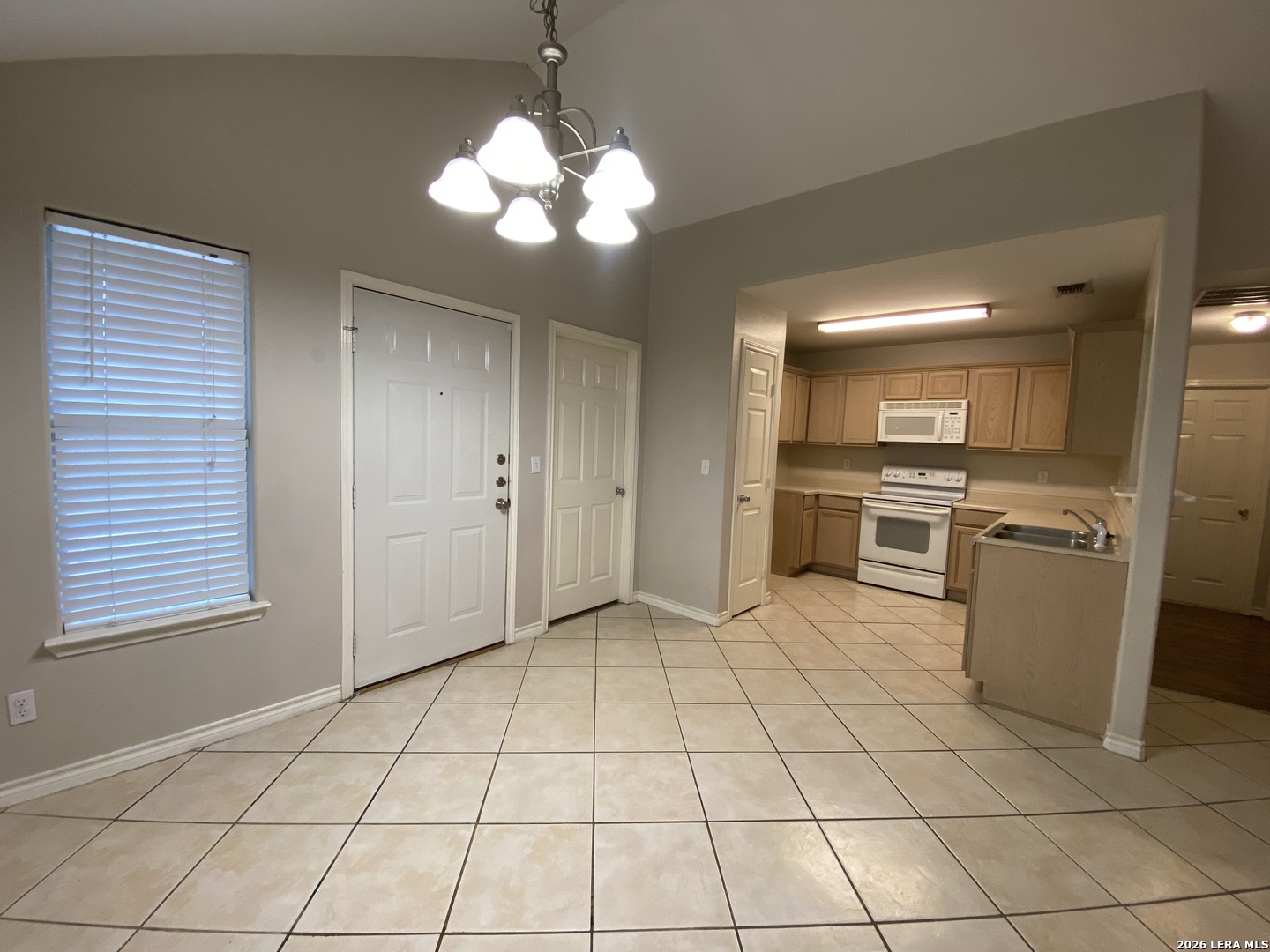 108 Ocotillo Jourdanton, TX 78026 - Photo 6 of 14 a view of a kitchen with microwave and cabinets