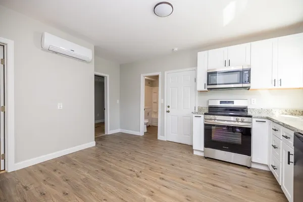 a kitchen with granite countertop a stove and a microwave