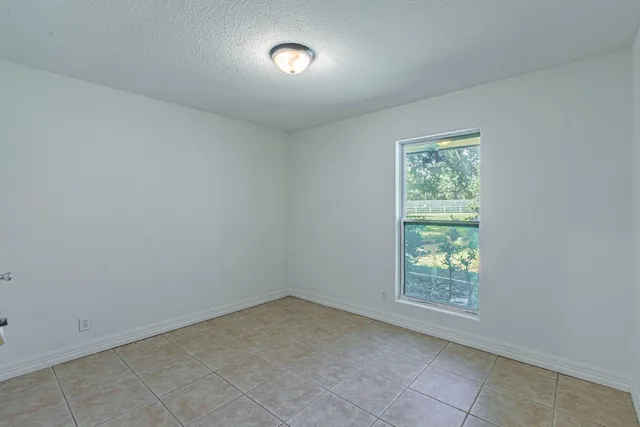 an empty room with a empty space and windows