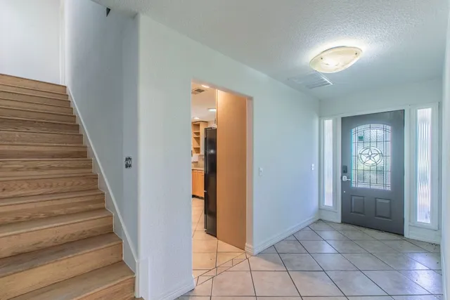 a kitchen with stainless steel appliances granite countertop a sink refrigerator and microwave