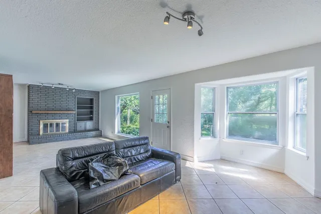 a kitchen with a sink window and cabinets