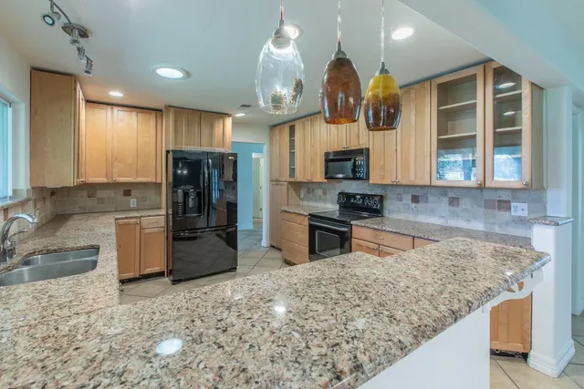 a view of a yard with a house in the background