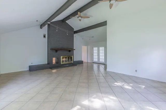 a view of empty room with a fireplace and cabinet