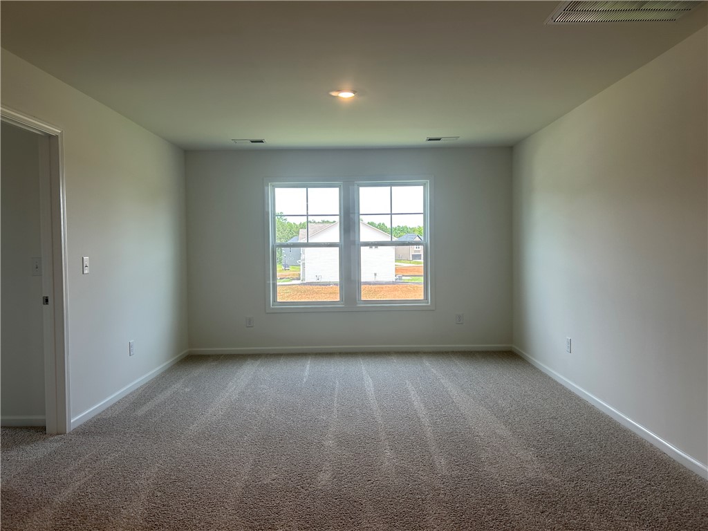 217 Bellflower Lane Anderson, SC 29625 - Photo 14 of 27 A quiet space awaits, with soft carpet underfoot and sun filtering through the window.