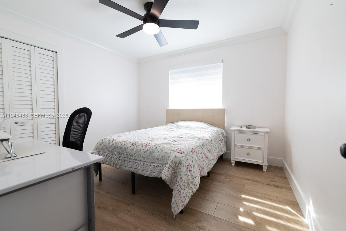 16141 Southwest 156th Avenue Miami, FL 33187 - Photo 19 of 35 a bed room with a bed and a television