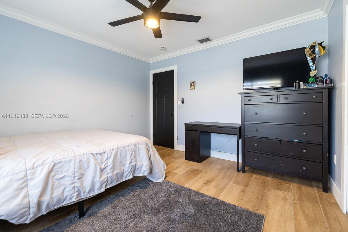 16141 Southwest 156th Avenue Miami, FL 33187 - Photo 21 of 35 a bedroom with a bed and a flat screen tv