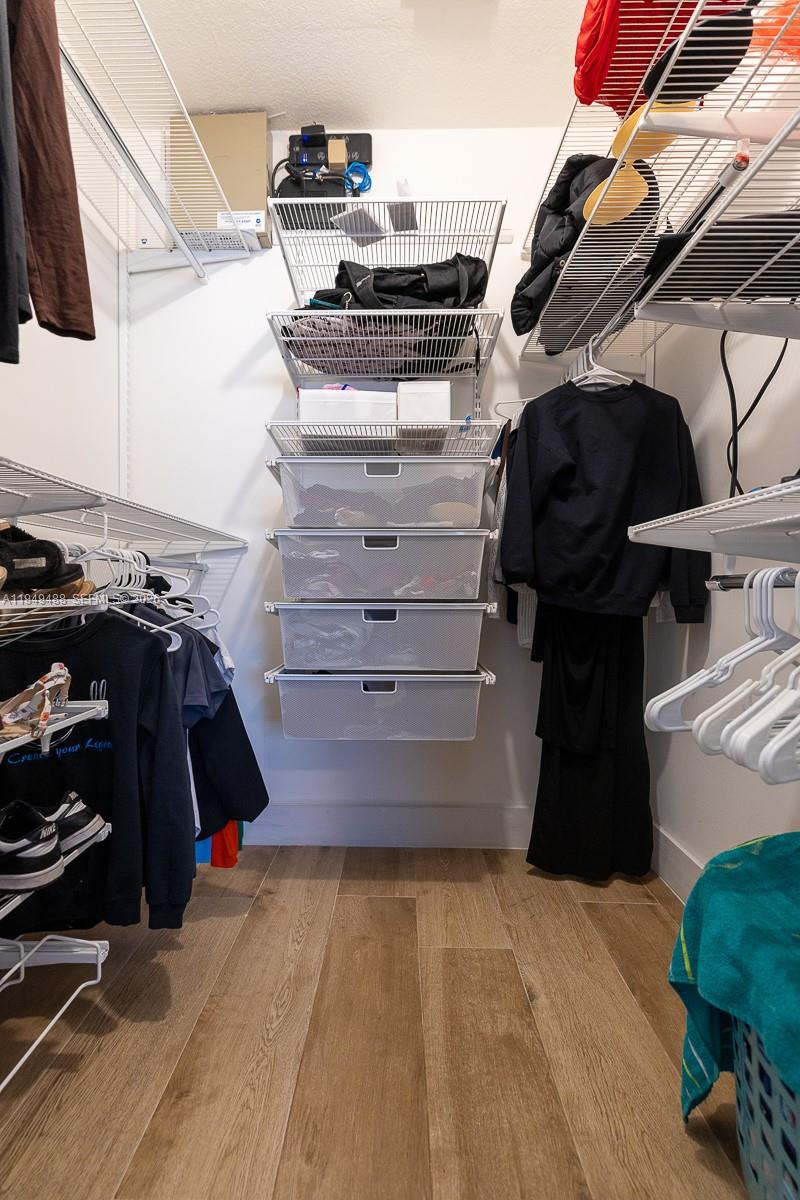 16141 Southwest 156th Avenue Miami, FL 33187 - Photo 24 of 35 a view of walk in closet with clothes and shoes