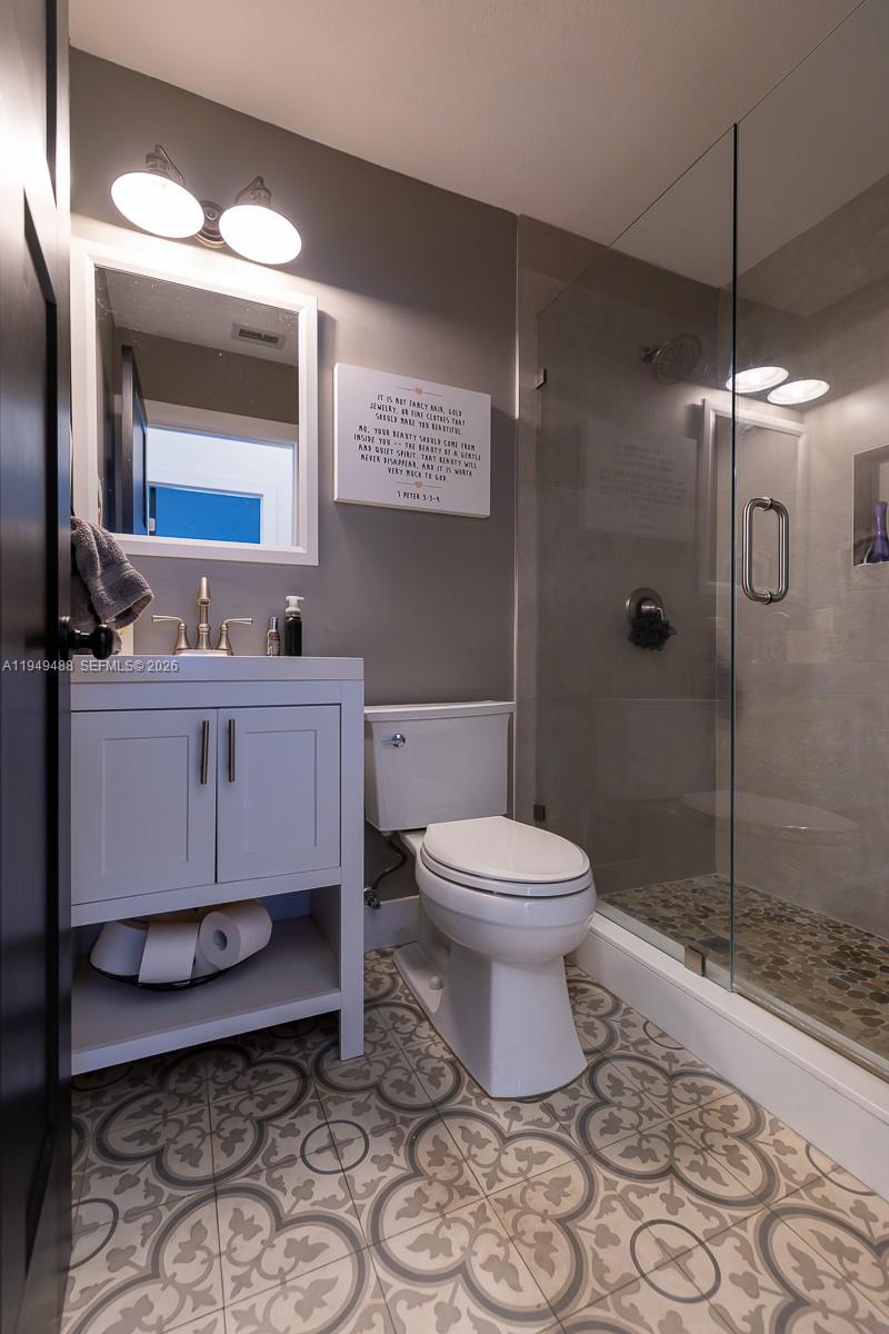 16141 Southwest 156th Avenue Miami, FL 33187 - Photo 26 of 35 a bathroom with a toilet sink and shower