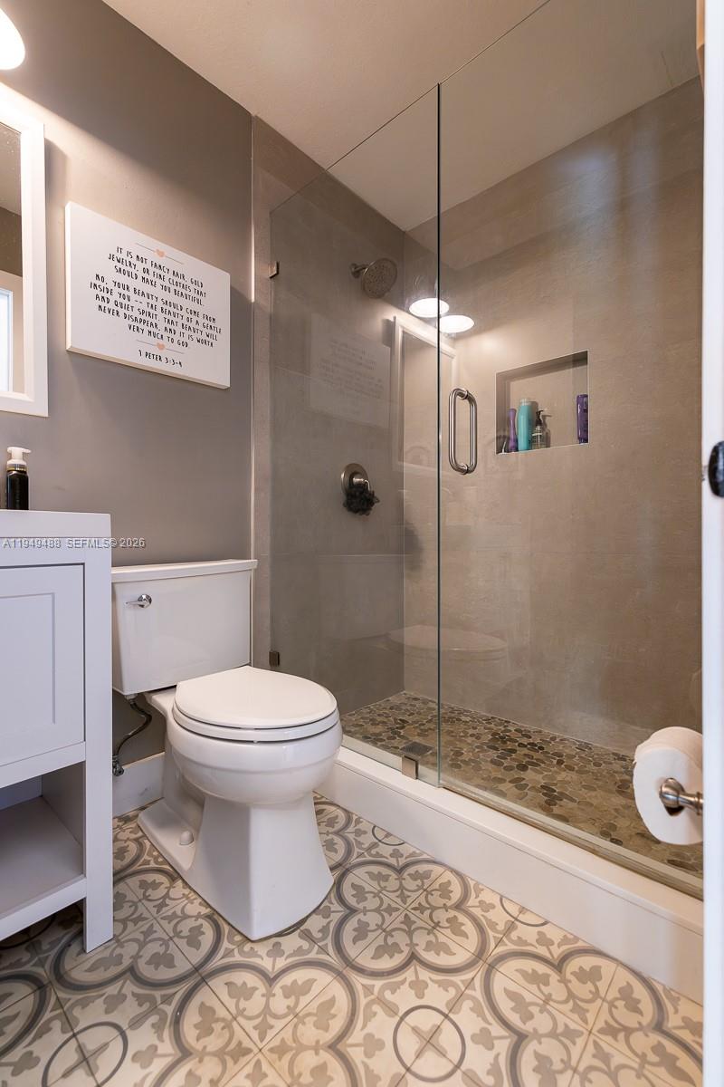 16141 Southwest 156th Avenue Miami, FL 33187 - Photo 27 of 35 a bathroom with a toilet and a shower