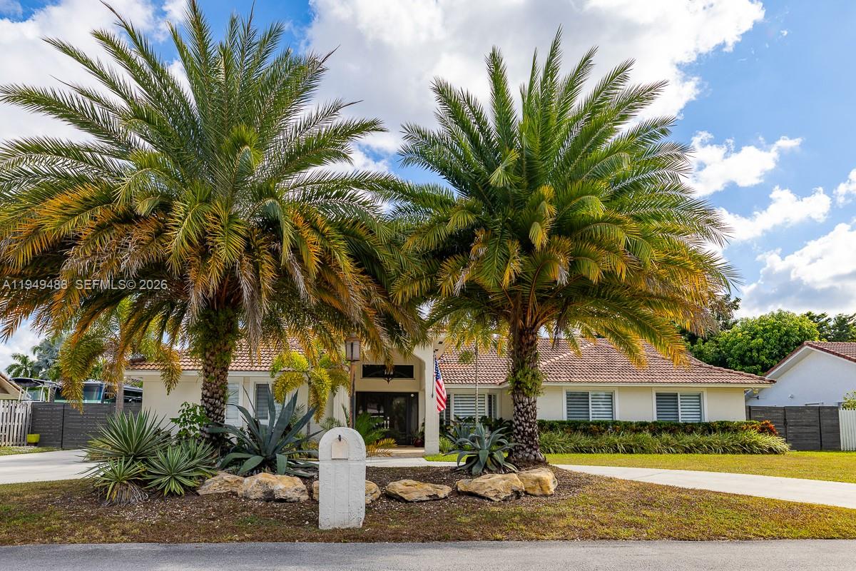 16141 Southwest 156th Avenue Miami, FL 33187 - Photo 3 of 35 a front view of a house with a garden