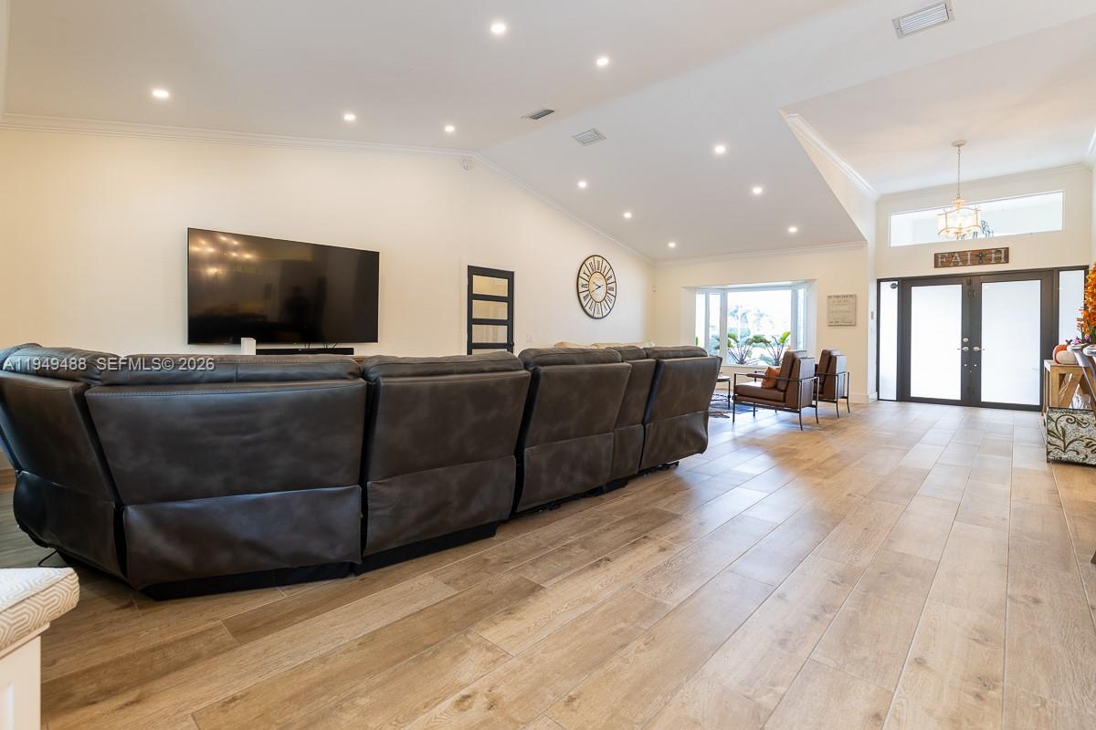 16141 Southwest 156th Avenue Miami, FL 33187 - Photo 8 of 35 a living room with furniture and a flat screen tv