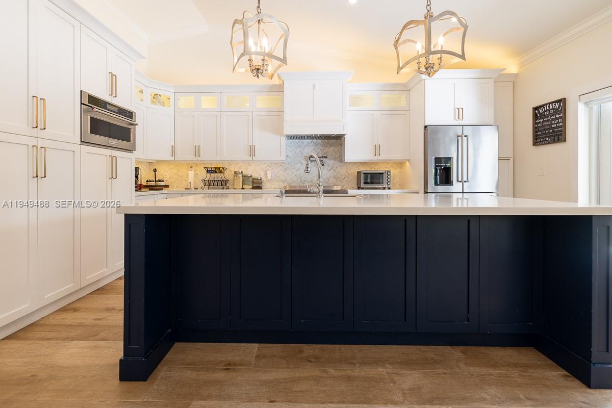 16141 Southwest 156th Avenue Miami, FL 33187 - Photo 10 of 35 a kitchen with stainless steel appliances a sink cabinets and wooden floor